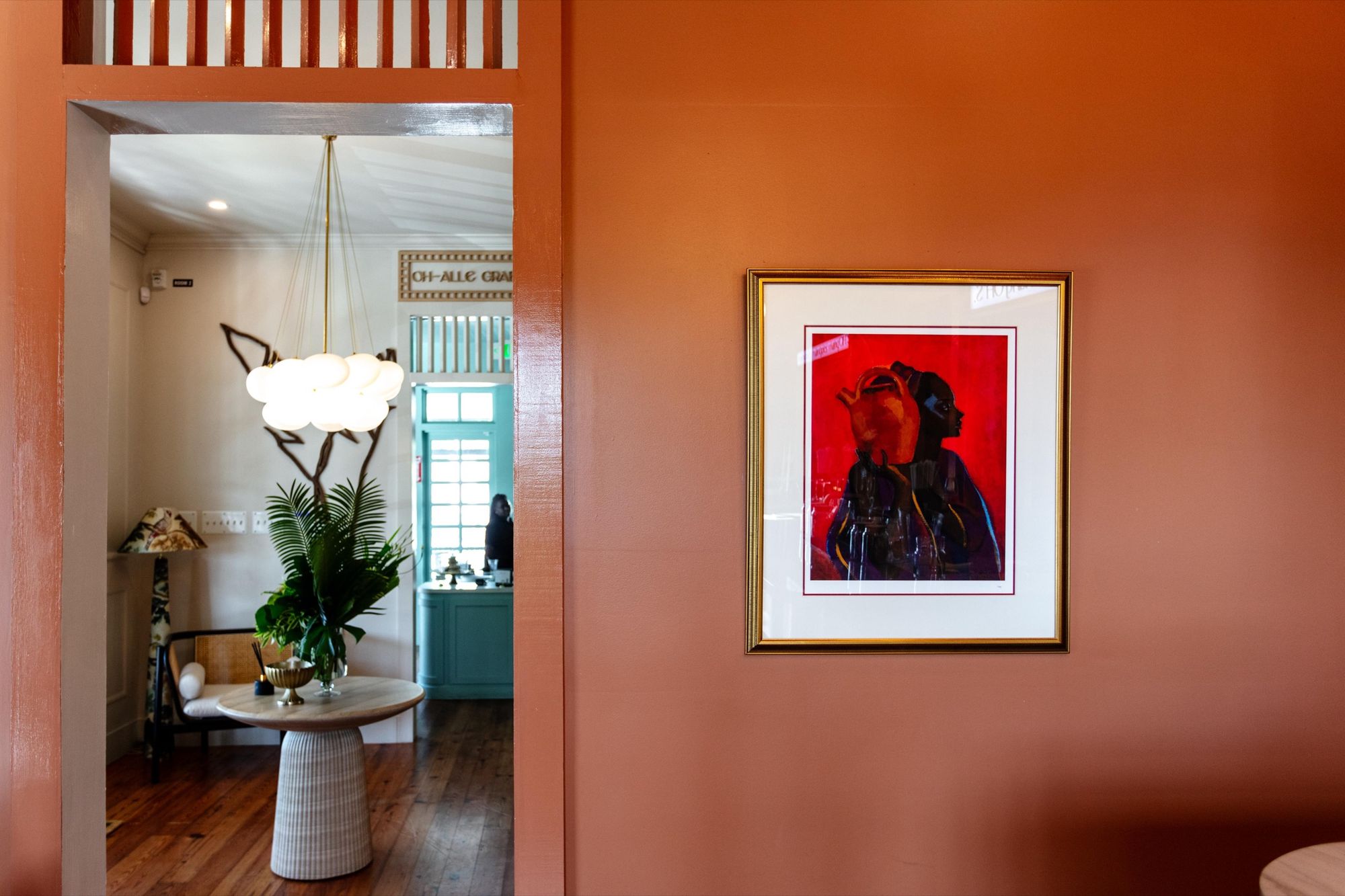 The terracotta entry hall of Olive House, looking through to the dining room